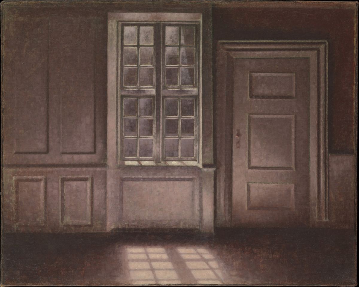 An empty gray room where moonlight from a tall window falls in squares across the floor.